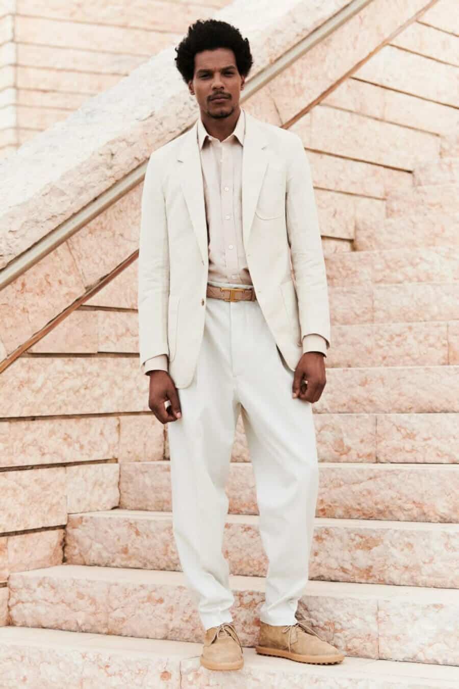 Men's all white outfit with relaxed trousers and blazer