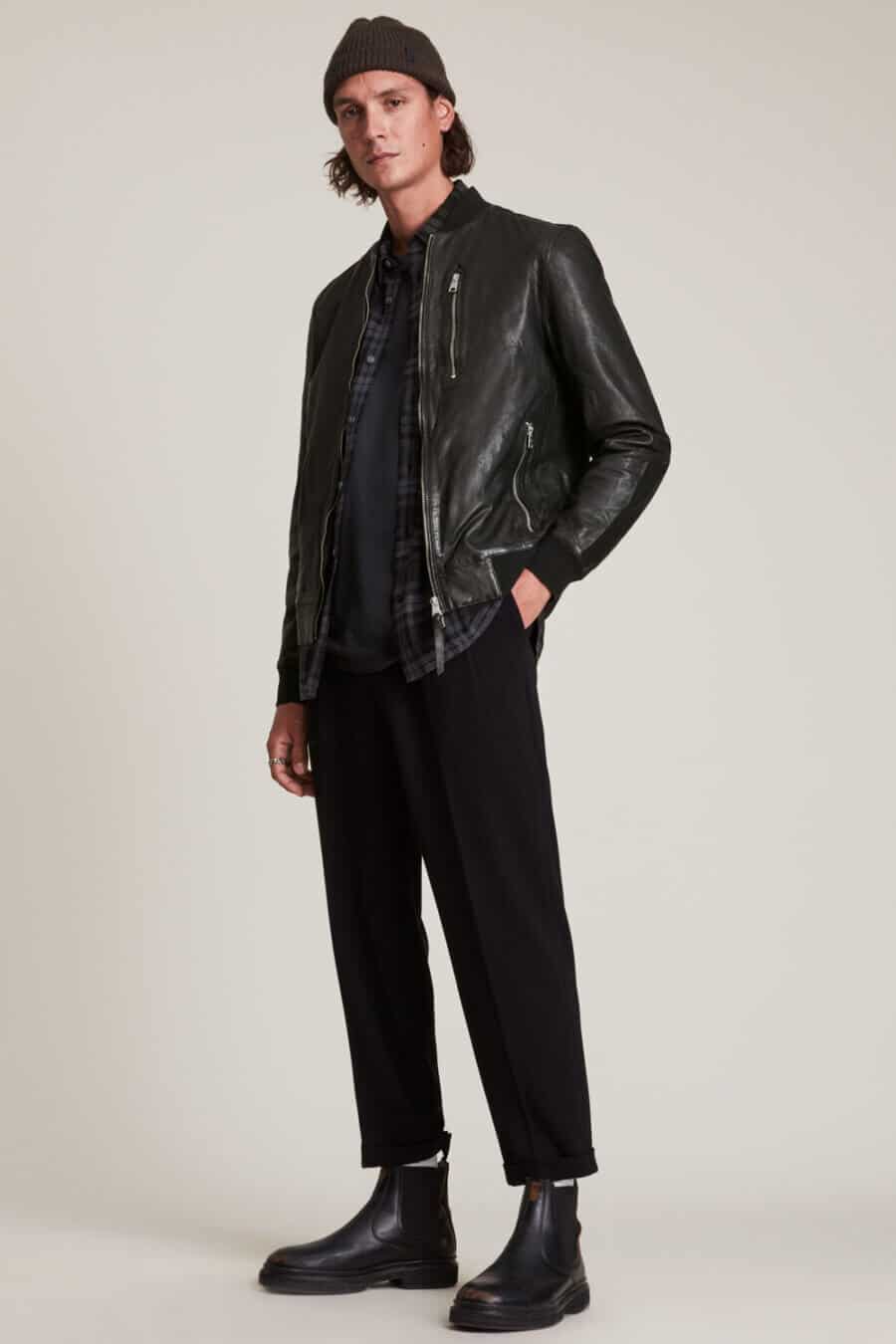 Men's all black edgy outfit with leather bomber jacket, cropped trousers and Chelsea boots
