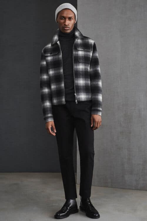 Men's all black outfit with turtleneck, checked wool overshirt, black chinos and boots