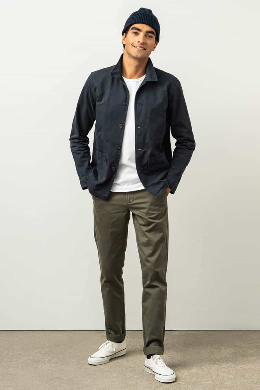 Men's green pants, white T-shirt, navy chore jacket and white sneakers outfit