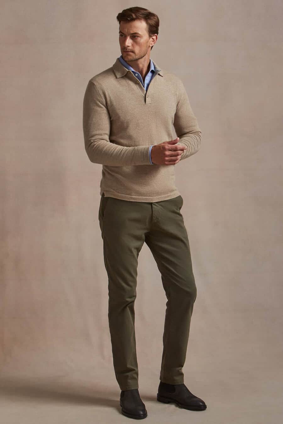 Men's olive chinos, zip neck sweater, blue shirt and chelsea boots outfit