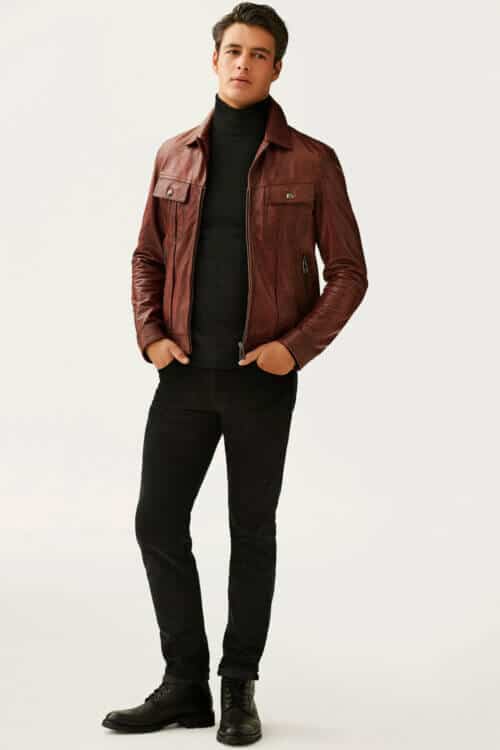 Men's brown leather jacket, black roll neck, jeans and boots outfit