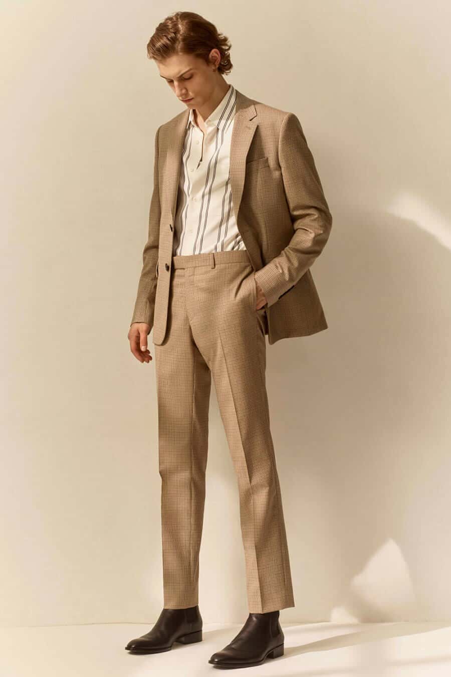 Men's camel suit and striped shirt with brown chelsea boots