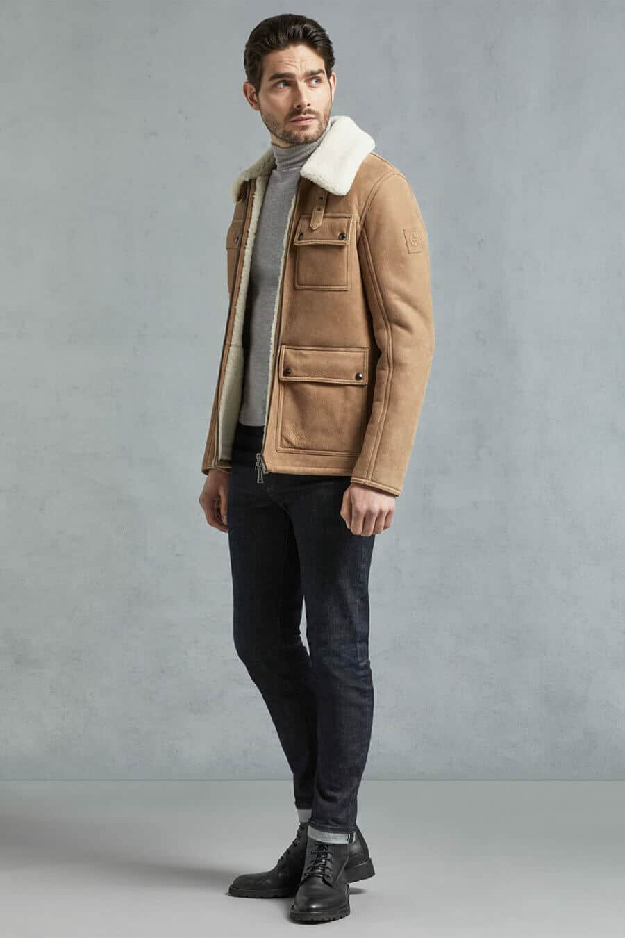Men's military inspired turtleneck outfit with shearling jacket, jeans and boots