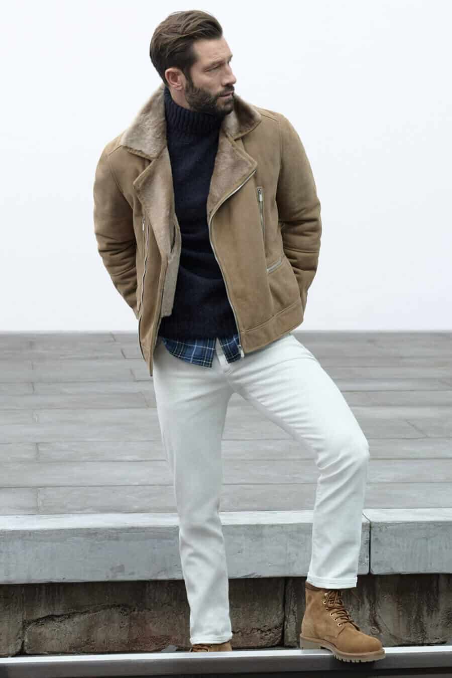 Rugged winter turtleneck outfit for men with shearling biker jacket and white jeans