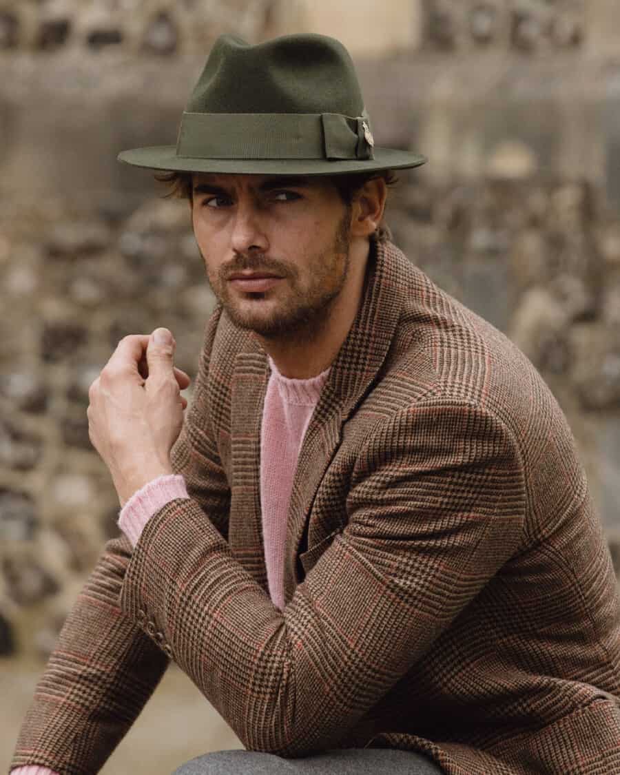 Man wearing a green wool Christys' London fedora with a pink sweater and brown tweed blazer