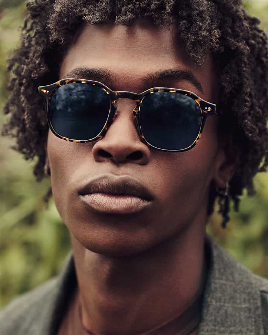 Black man wearing a cool pair of tortoiseshell sunglasses