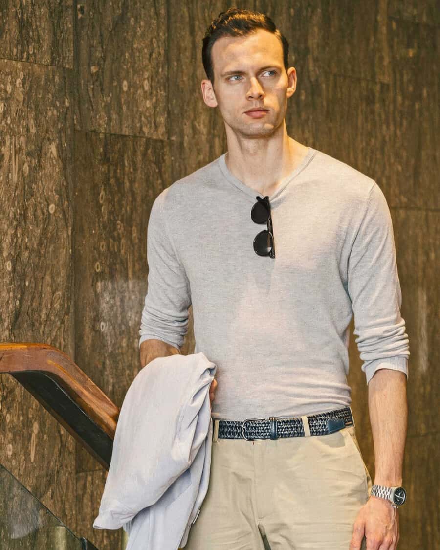 Man wearing khaki pants, woven blue Anderson’s belt and tucked in grey long-sleeve top