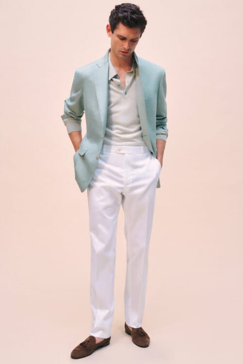 Men's white pants, light green tucked in polo shirt, blue-green unstructured blazer and brown suede tassel loafers Italian style