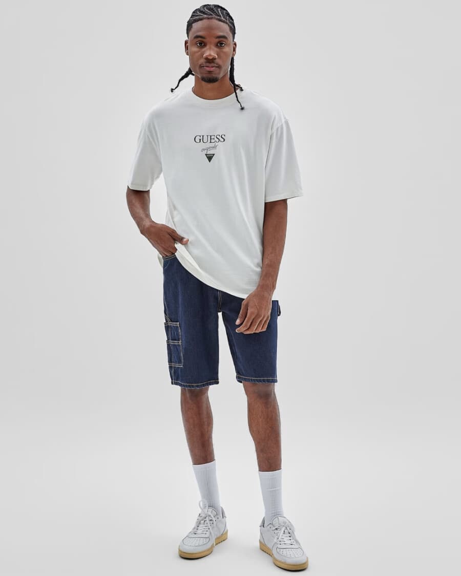 Men's white logo T-shirt, denim cargo shorts, white socks and chunky white gum sole sneakers outfit