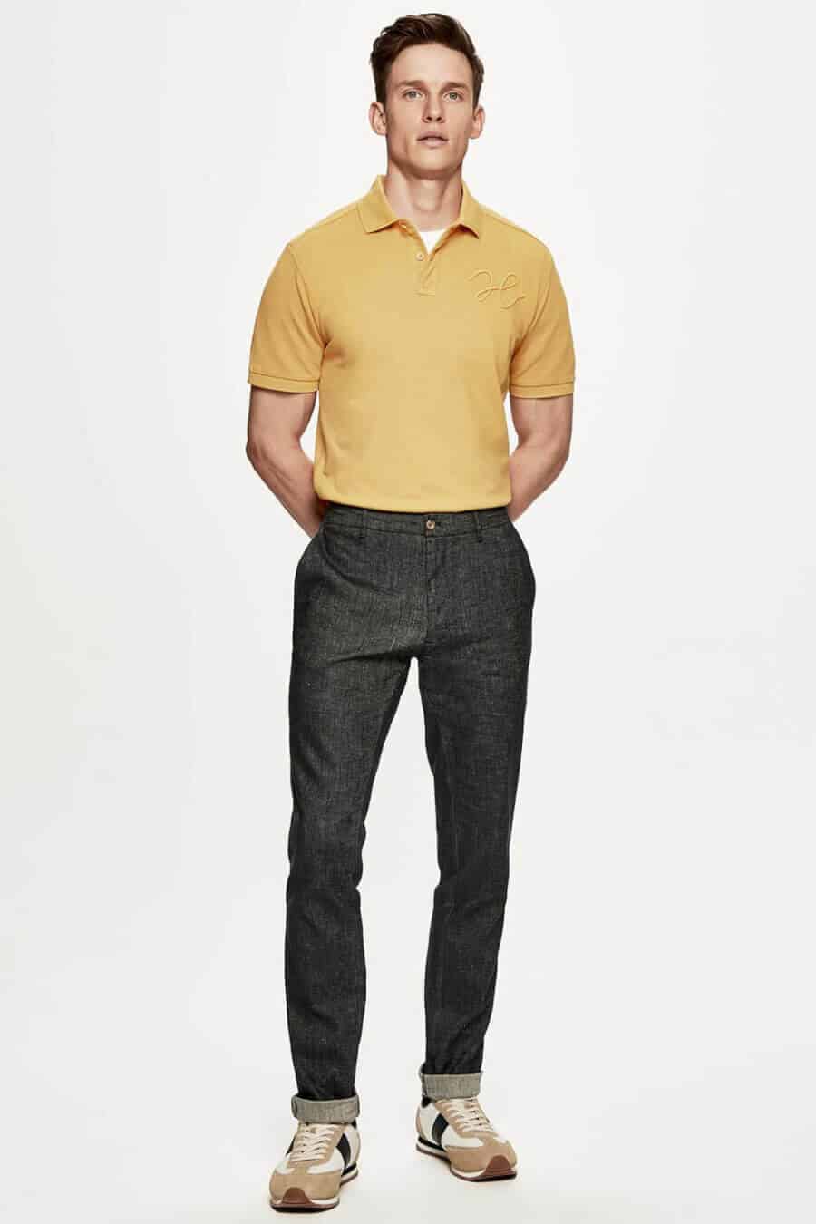 Men's bold yellow polo shirt with jeans and running shoes outfit