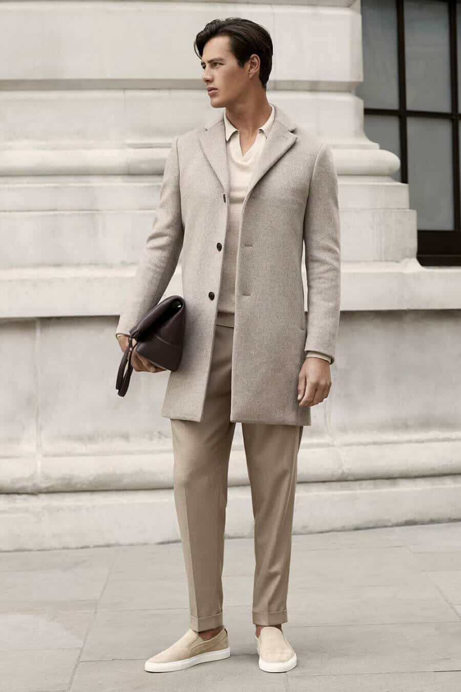 Men's tonal outfit with beige trousers, overcoat and knitted polo shirt
