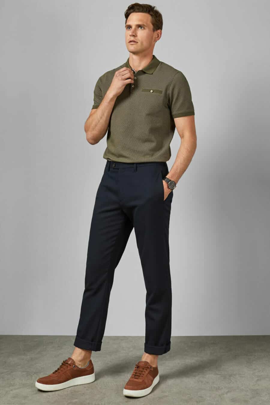 Men's tucked in polo shirt, chinos and sneakers outfit
