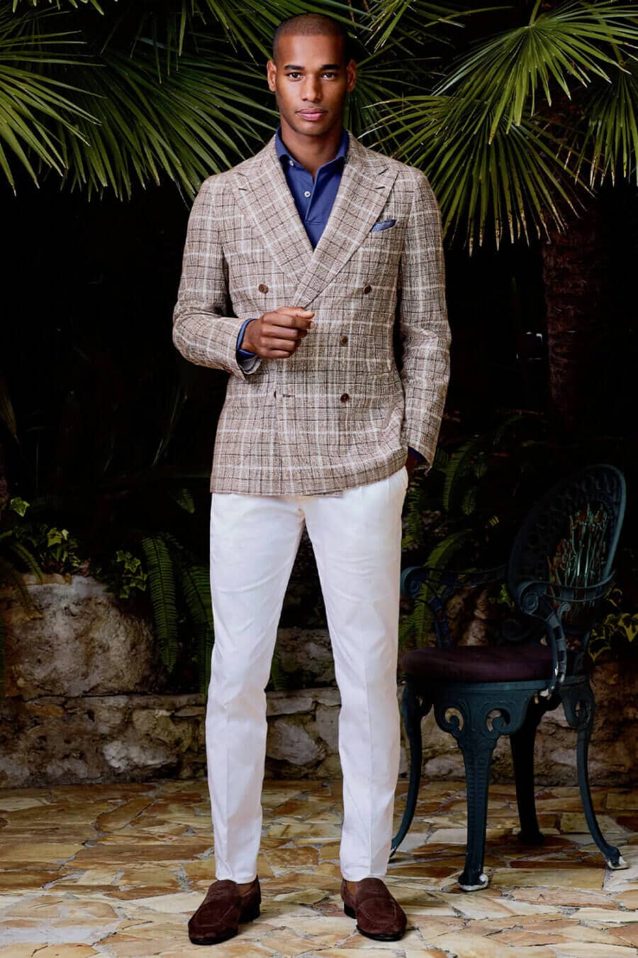 Men's white pants, long sleeve blue polo shirt, double-breasted brown check blazer and brown suede penny loafers outfit