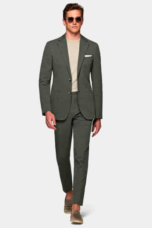 Men's unstructured tailoring trend - green linen suit with knitted tee and suede loafers outfit