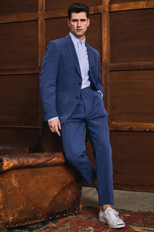 Men's unstructured striped suit worn with white sneakers