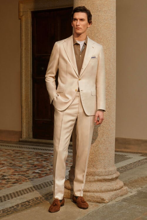 Men's Italian unstructured beige suit worn with brown polo shirt and brown suede tassel loafers