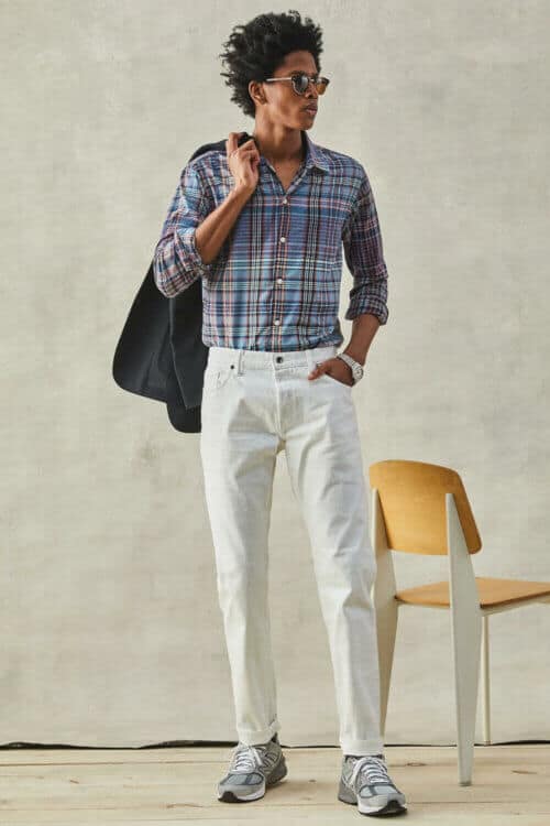 Men's white jeans and madras shirt outfit with sneakers