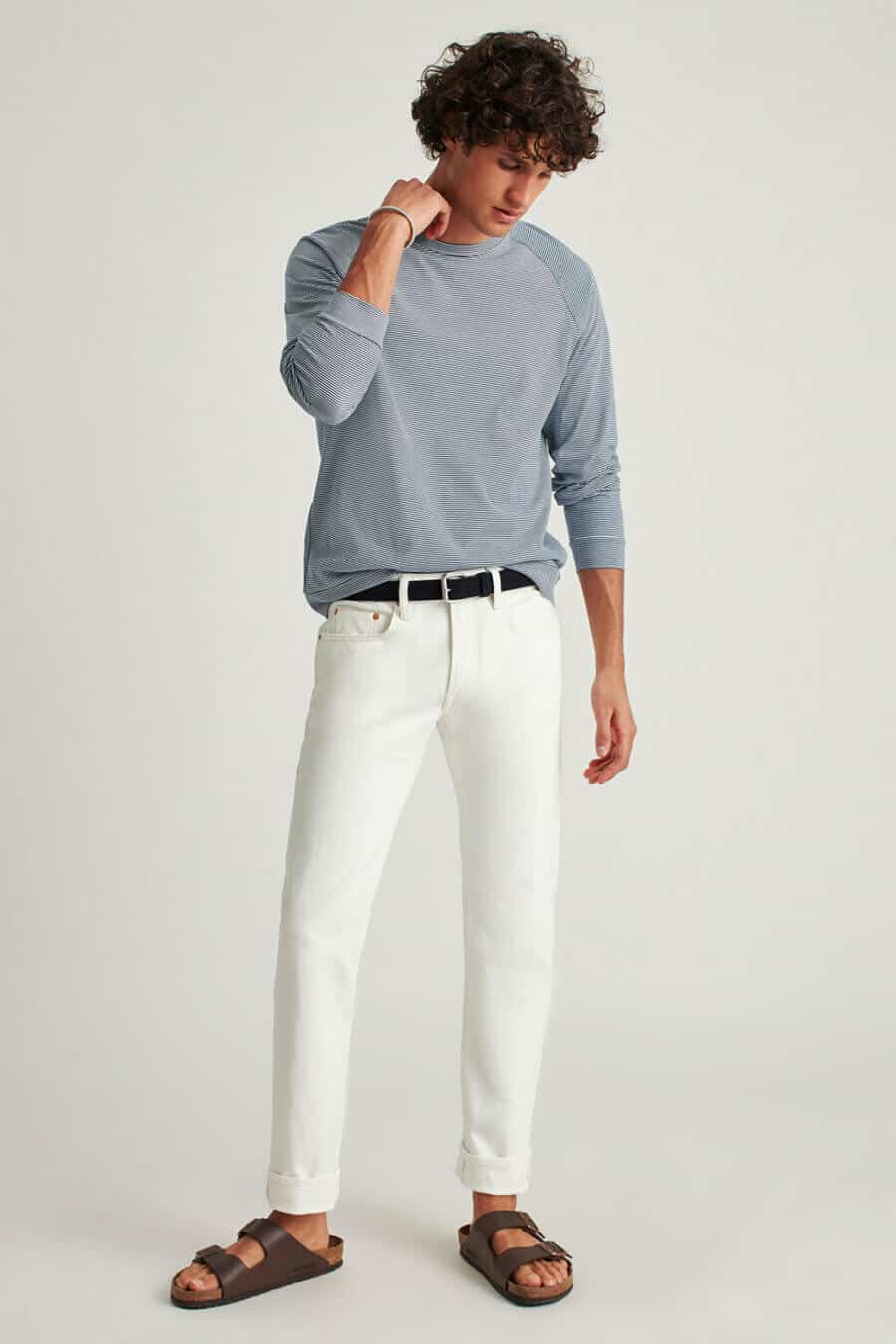 Men's white jeans with top and brown leather sandals outfit