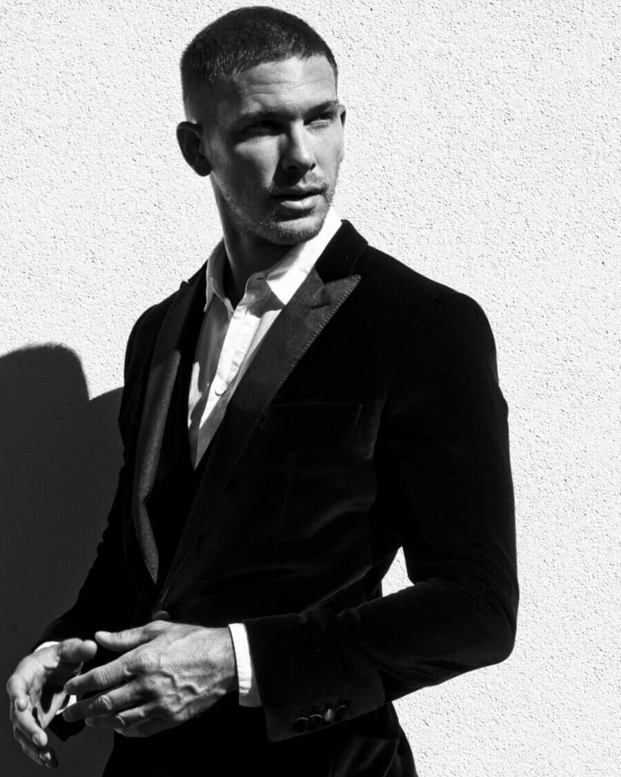 Male model Adam Senn wearing a white shirt and black velvet blazer