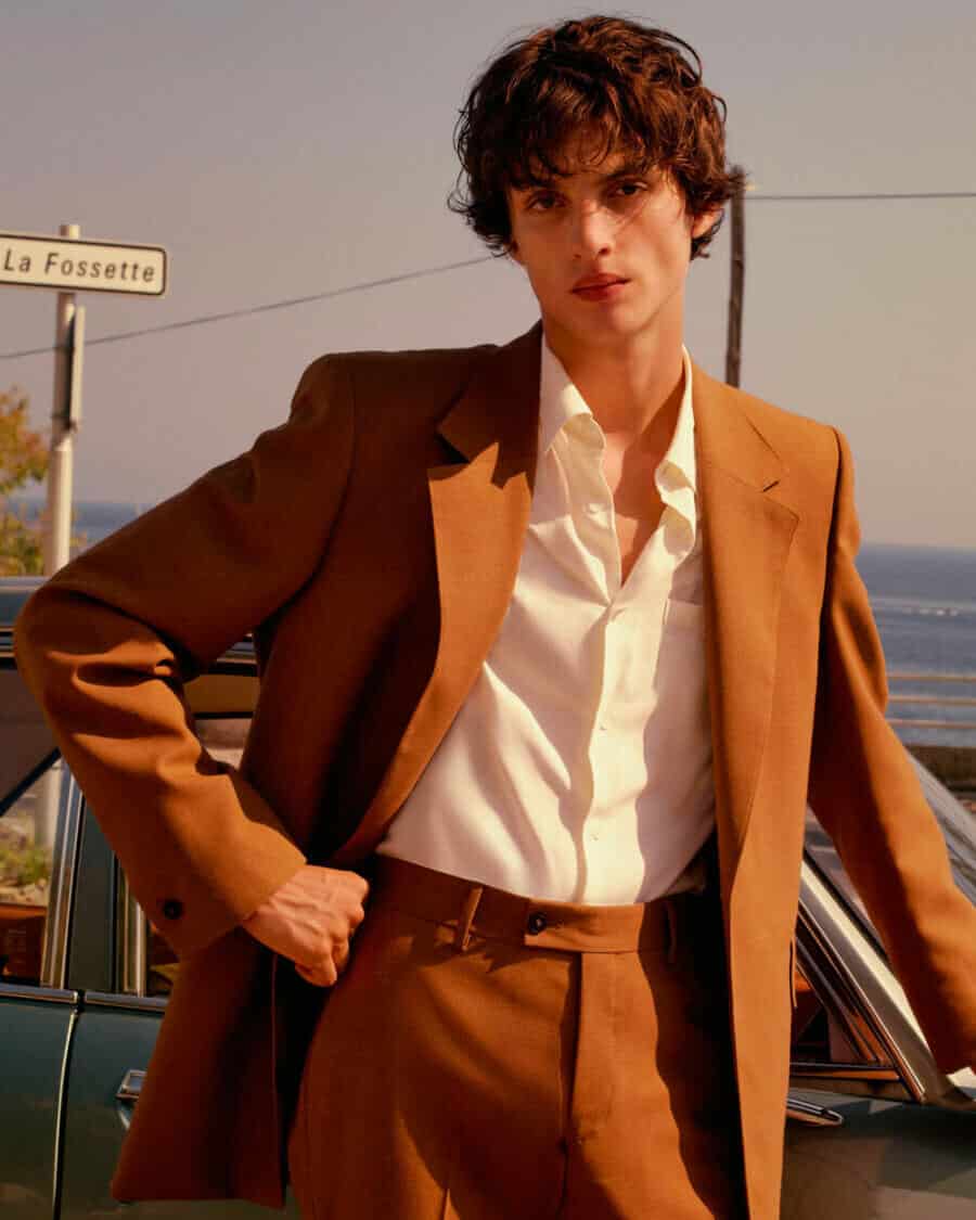 Male model Lucas El Bali wearing a tan brown suit and white shirt