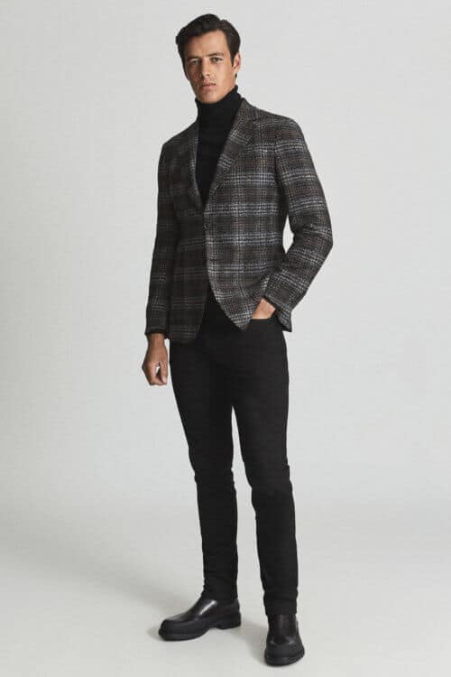 Men's black jeans with checked blazer and black turtleneck outfit