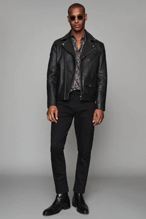 Men's black jeans, patterned shirt and black leather jacket outfit