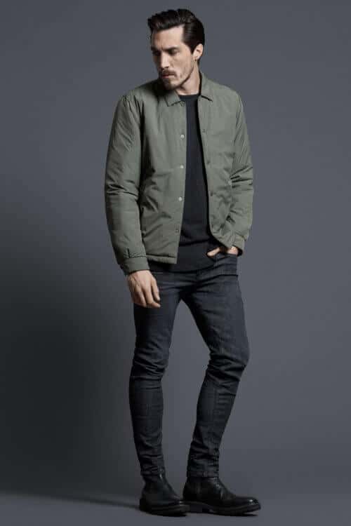 Men's black jeans and green padded overshirt outfit