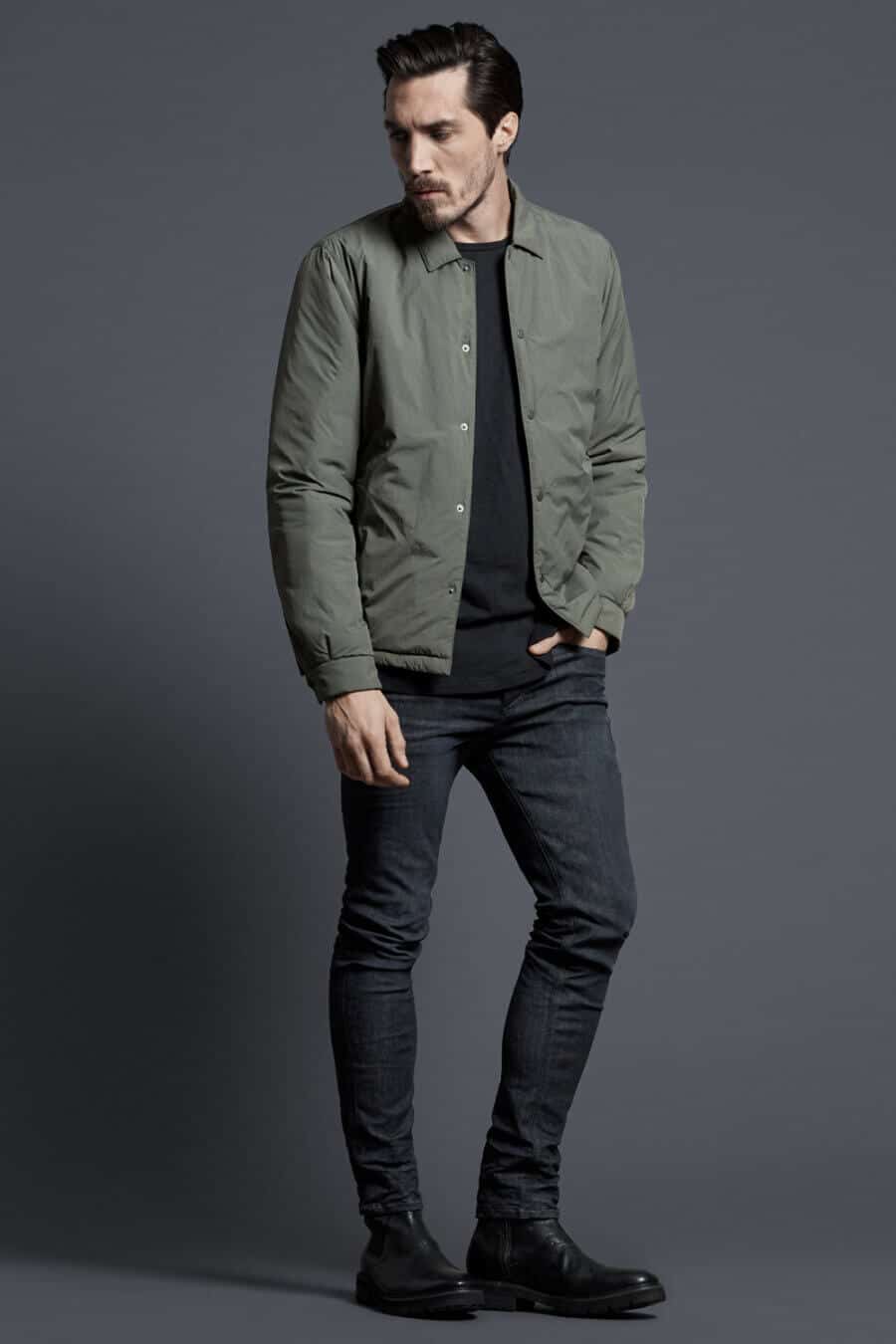 Men's black jeans and green padded overshirt outfit