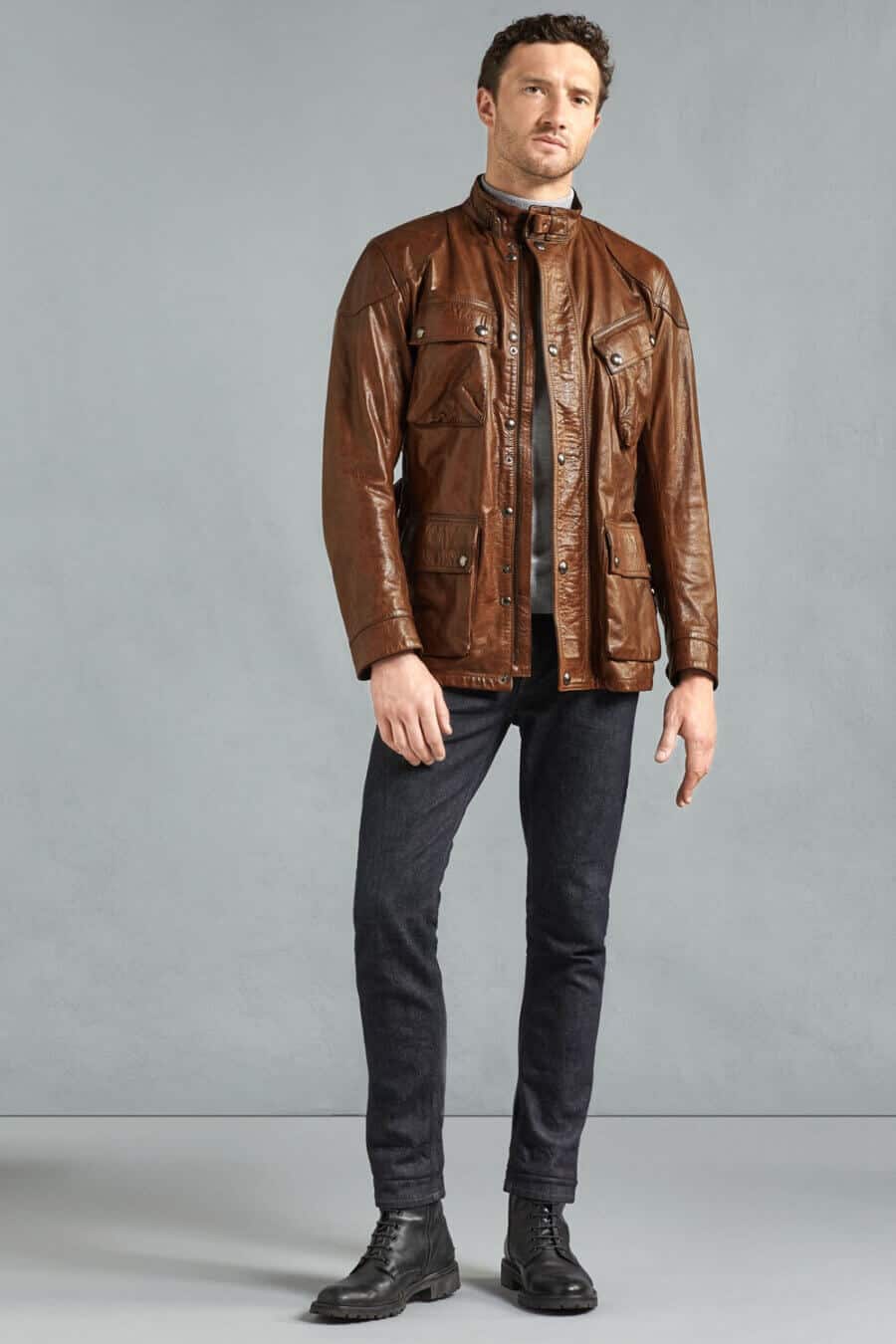 Men's black jeans and brown leather motorcycle jacket outfit