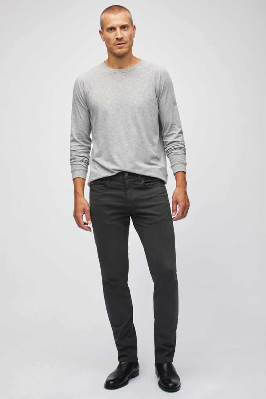 Men's black jeans and boots with grey long sleeve top outfit