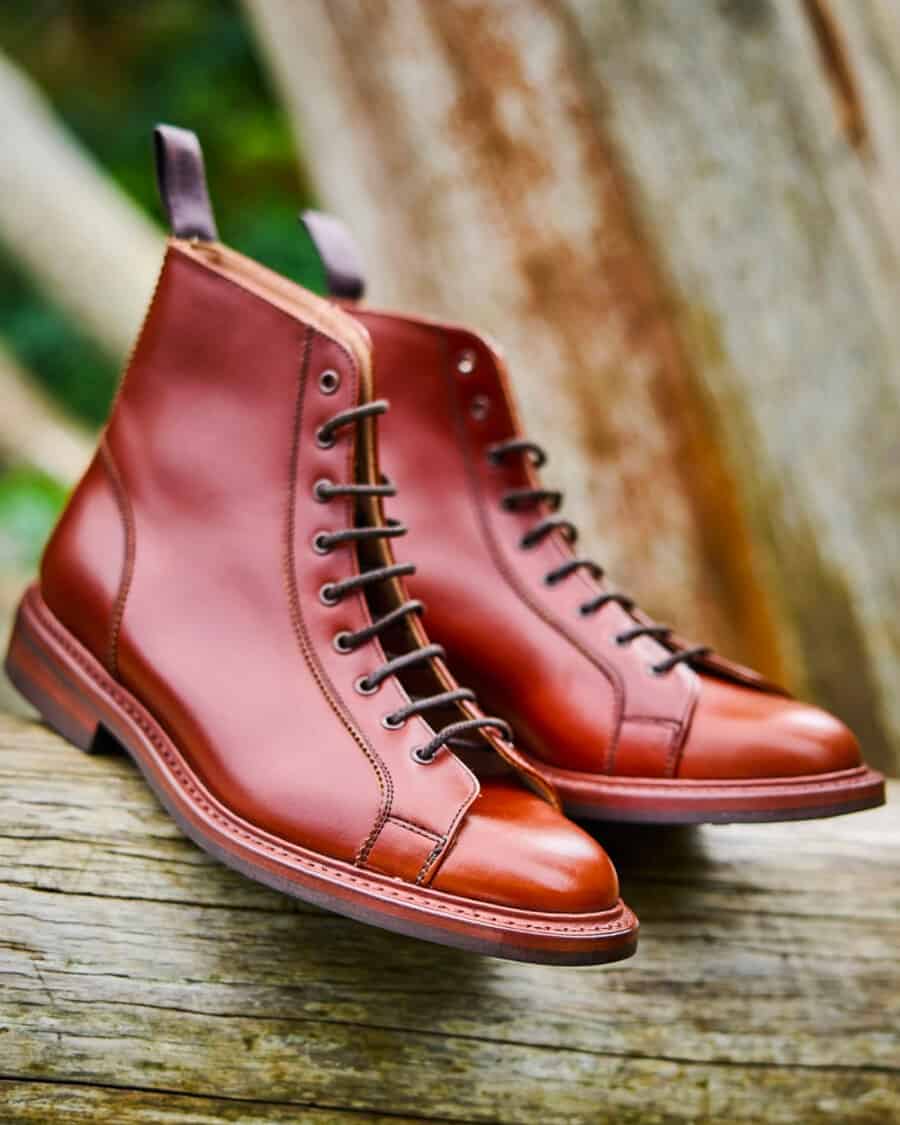 A pair of burgundy-brown leather Tricker's men's boots with heel tab