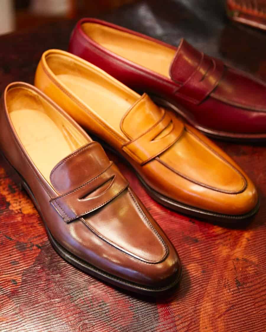 Three pairs of luxury Alfred Sargent penny loafers in brown, tan and burgundy leather
