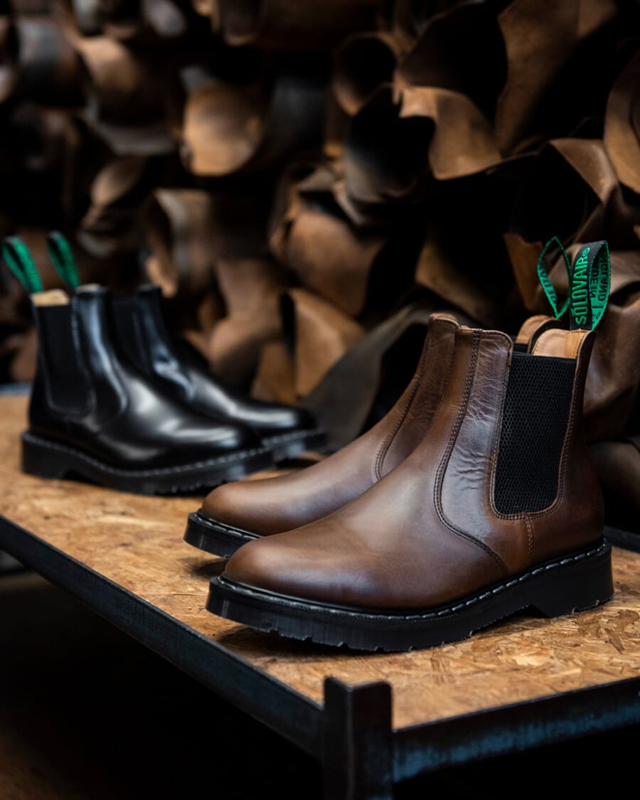 Two pairs of British made Solovair chunky sole leather Chelsea boots for men in black and brown with green heel tabs