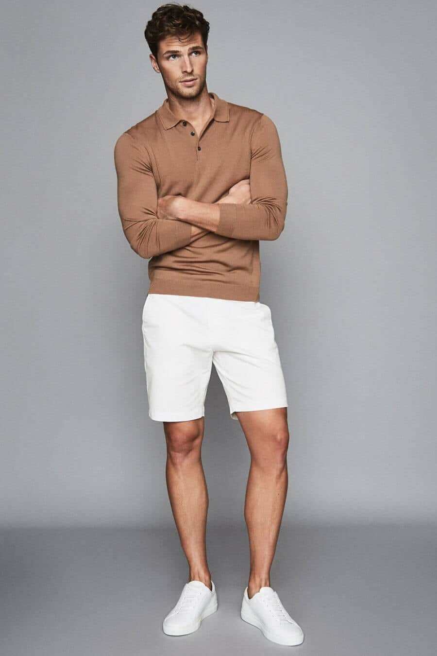 Men's white shorts, knitted polo shirt and sneakers summer outfit