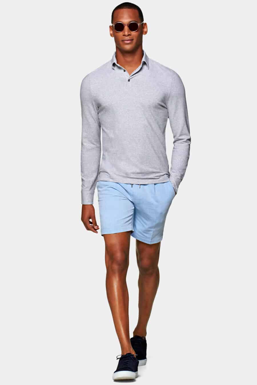 Men's pale blue shorts outfit with a shirt and grey v-neck sweater