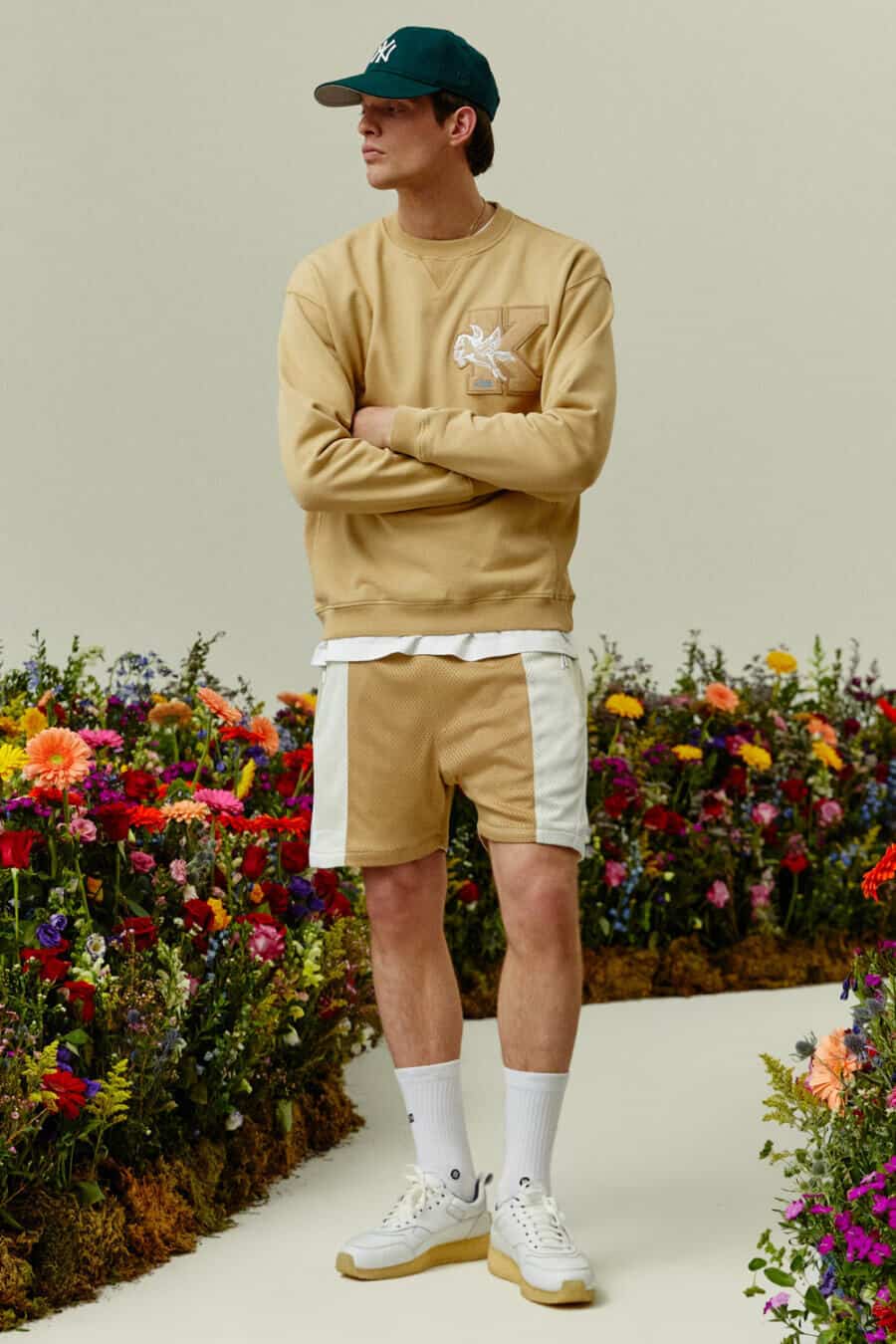 Men's co-ord shorts and sweatshirt outfit with sneakers and baseball cap