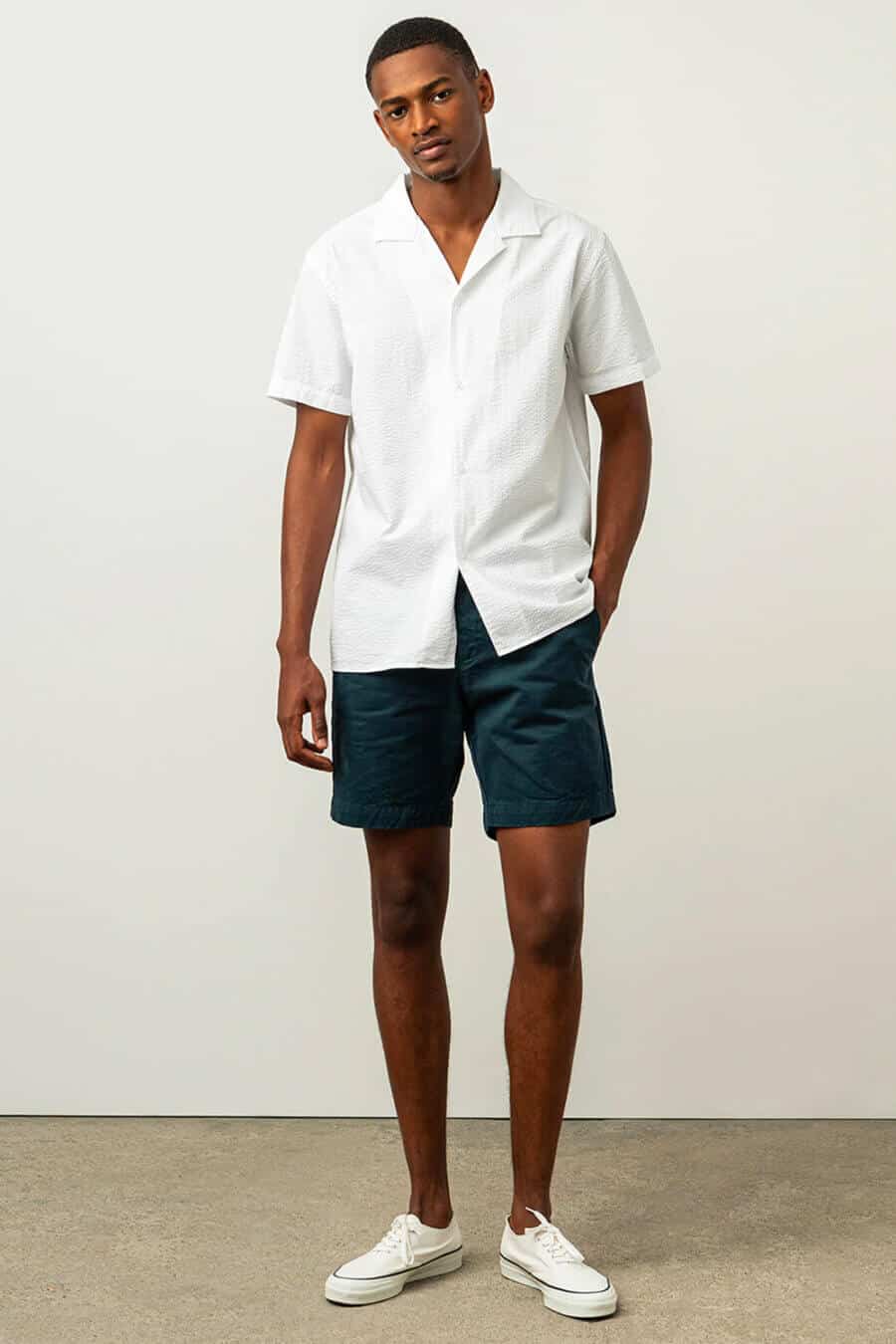 Men's navy shorts with white Cuban collar shirt and sneakers outfit
