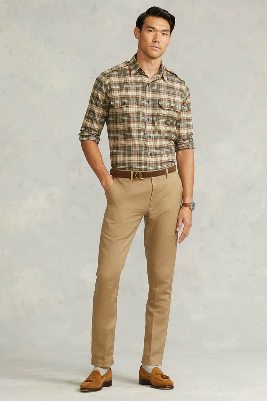 Men's khaki pants worn with a check shirt and suede loafers outfit