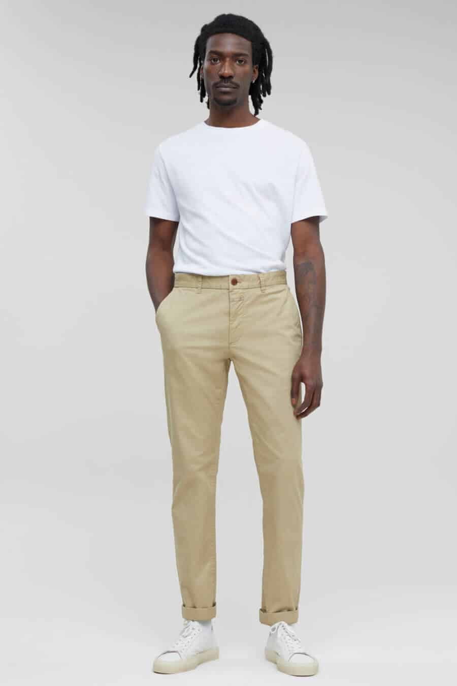 Men's simple khaki pants outfit with a white t-shirt and sneakers