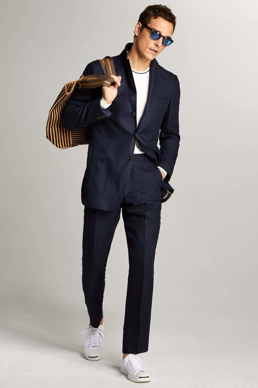 Men's navy suit, white top and white sneakers outfit