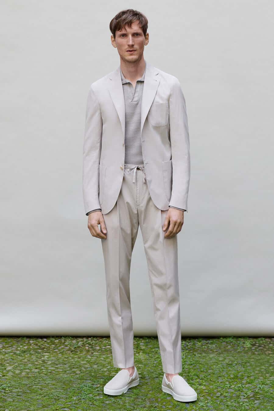 Men's light grey suit, polo shirt and sneakers outfit