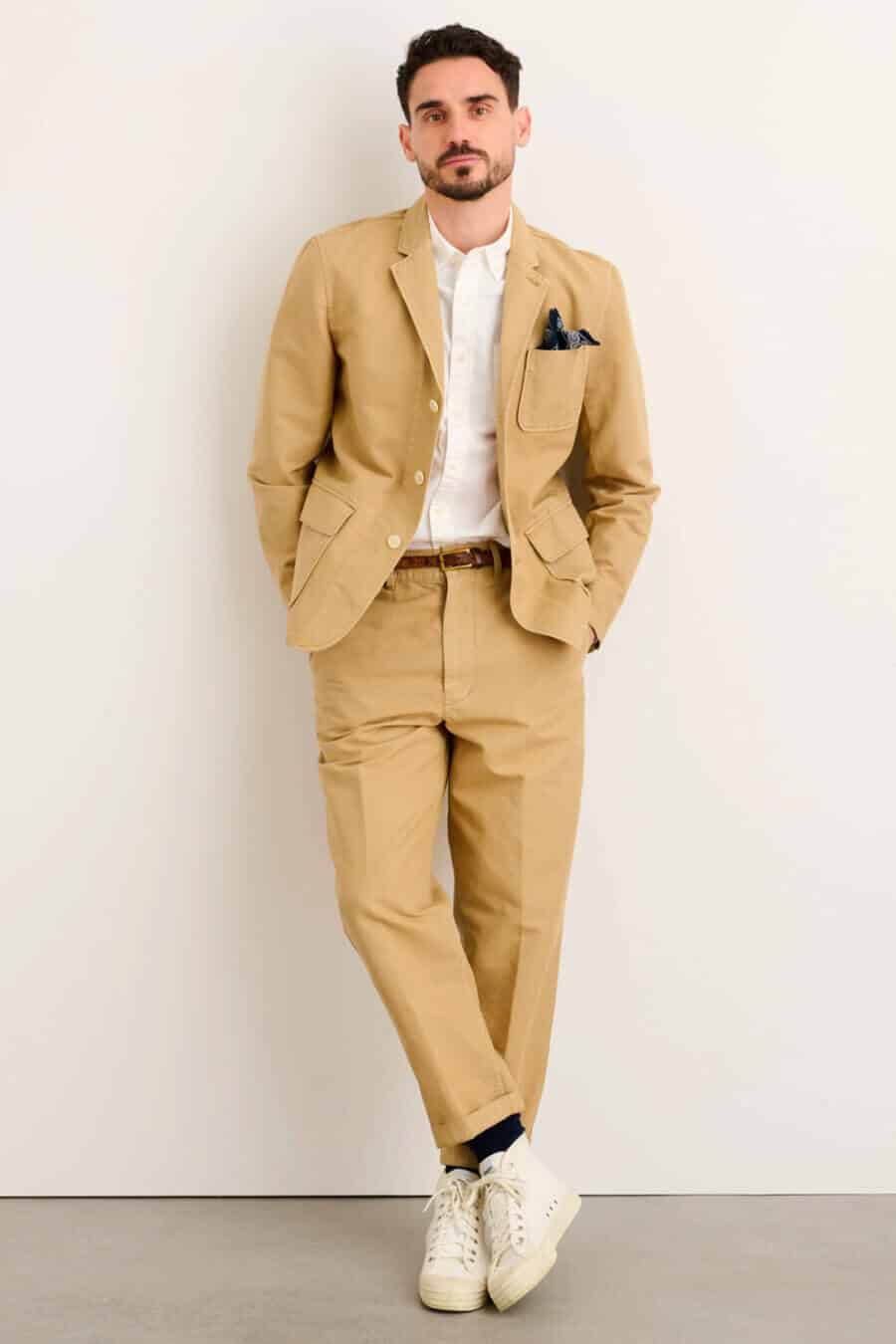 Men's beige cotton workwear suit with a white shirt and canvas sneakers outfit