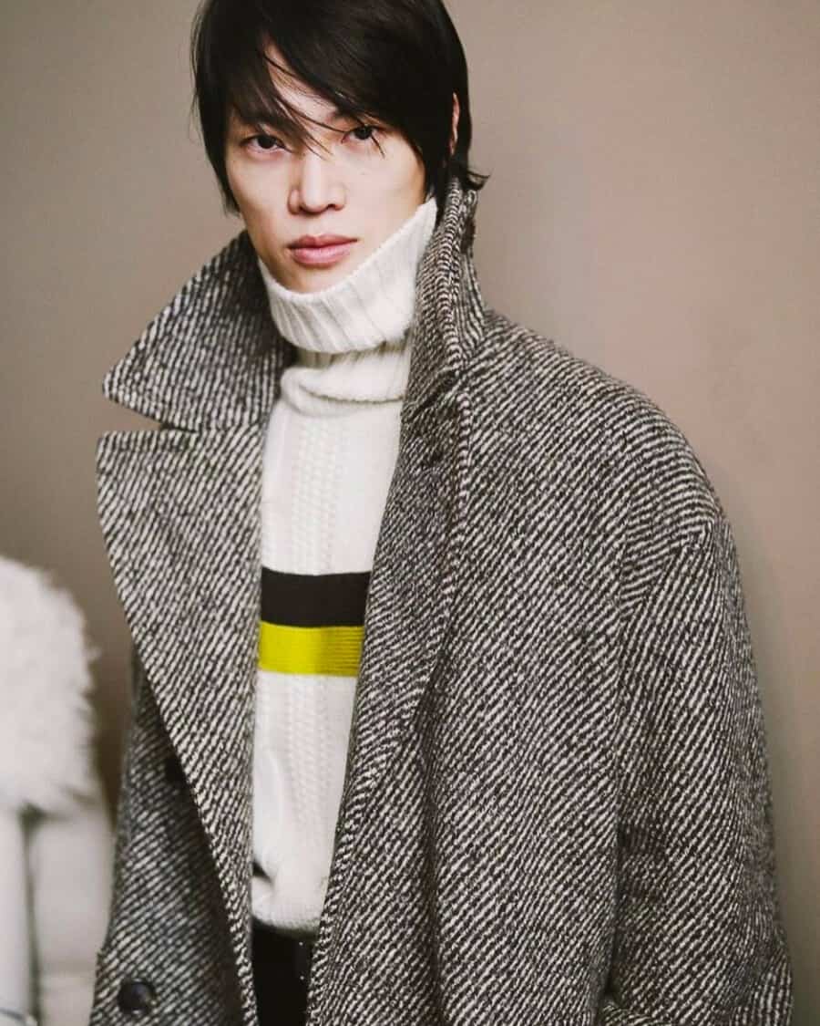 Korean male model Ungho Go wearing a white chunky roll neck jumper and oversized herringbone overcoat
