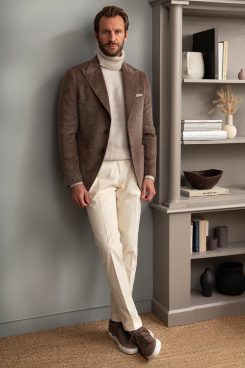 Men's cream trousers, stone roll neck and brown corduroy blazer outfit