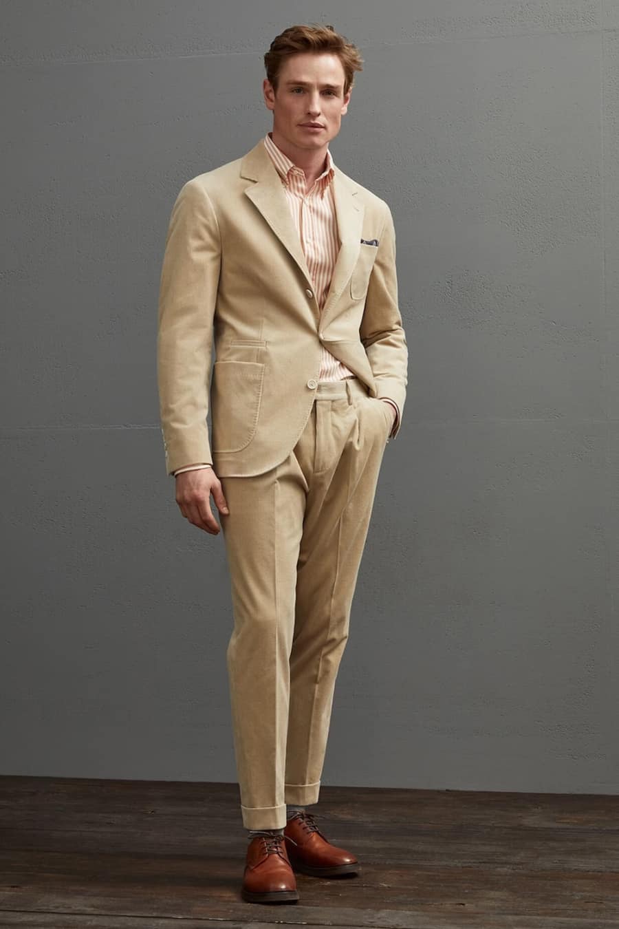 Men's beige corduroy suit worn with tan brown shoes