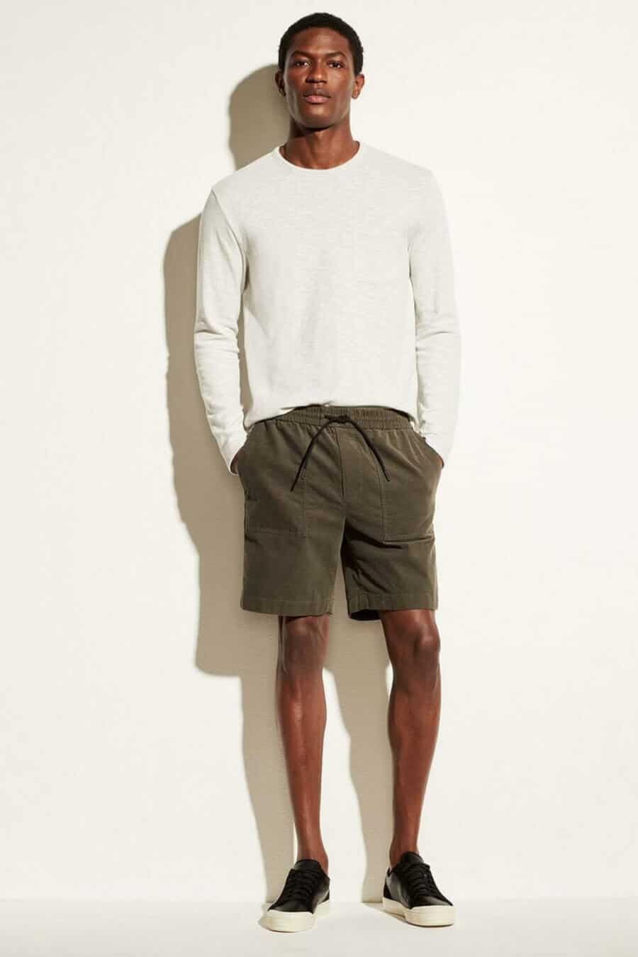 Men's summer outfit: drawstrong shorts, long white top and sneakers