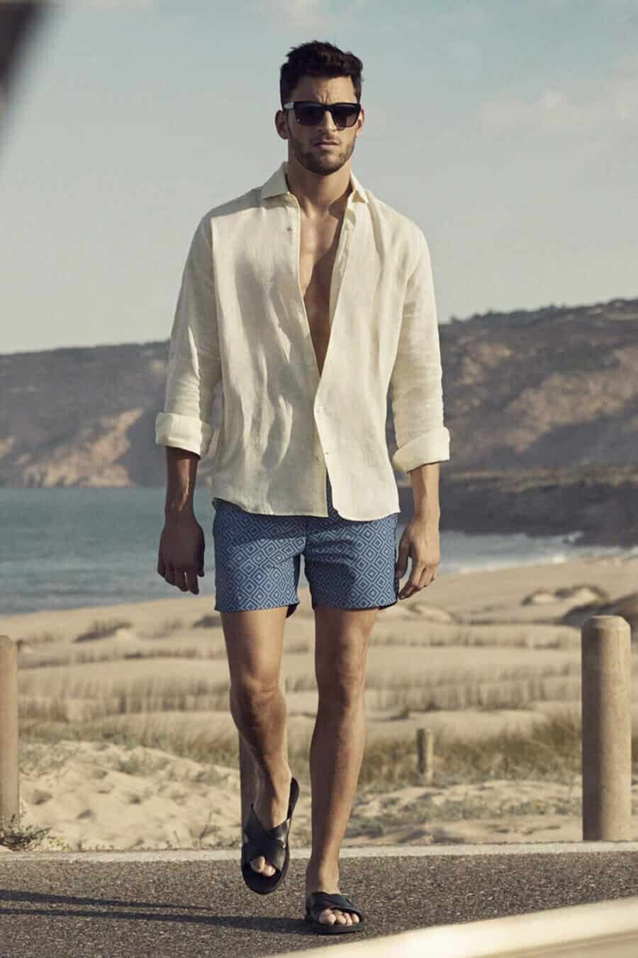 Men's beach summer outfit - swim shorts, sandals and open linen shirt