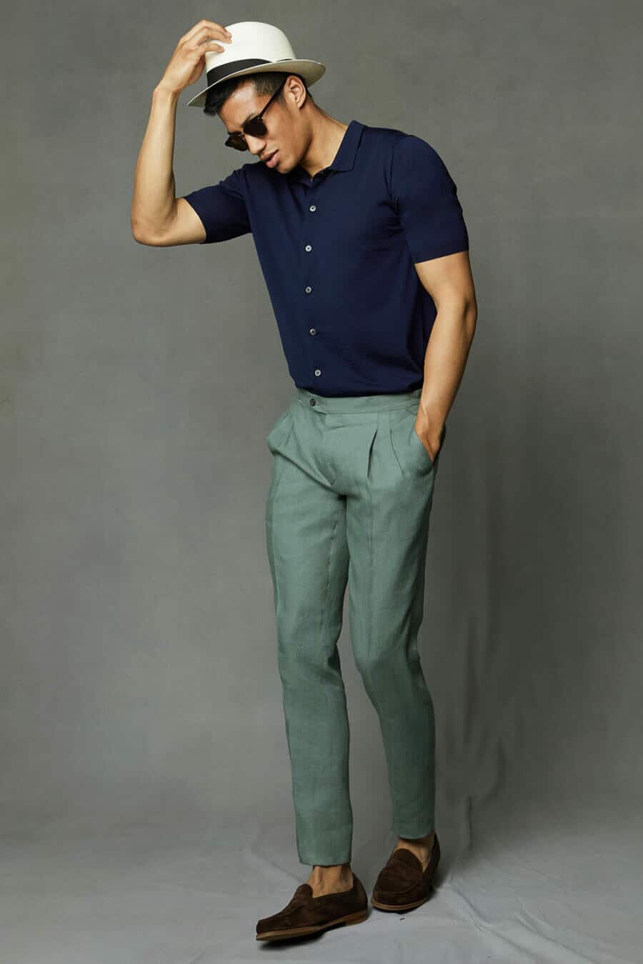 Men's summer outfit with Cuban collar shirt, pleated linen trousers, straw fedora and suede penny loafers