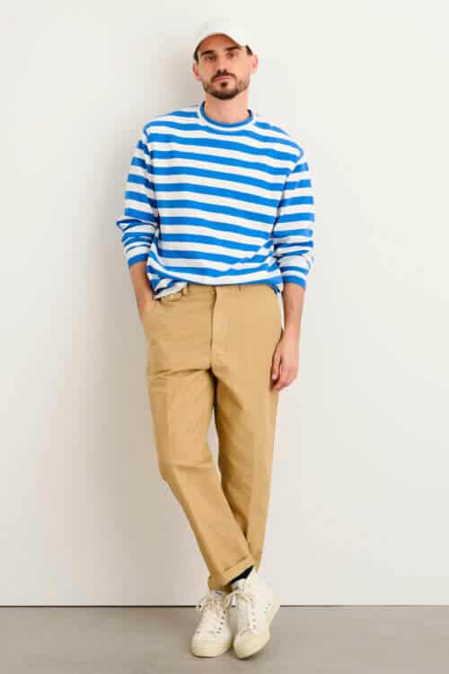 Men's summer breton top and relaxed leg chinos with white sneakers and baseball cap outfit